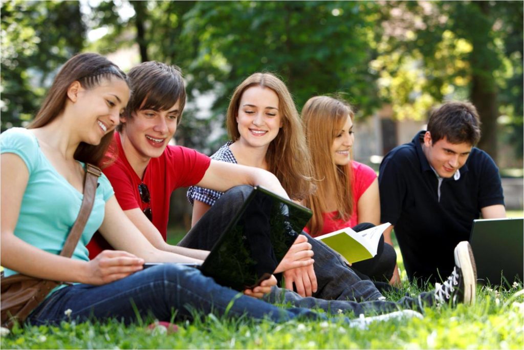college students looking at computers