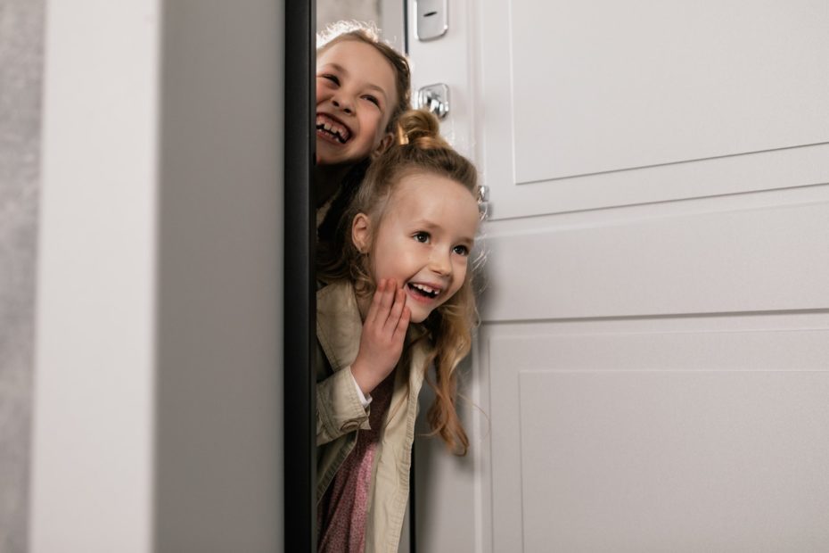 Two daughters playing on a road trip