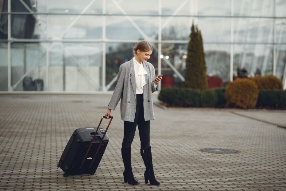 Woman waiting for airport shuttle to arrive.